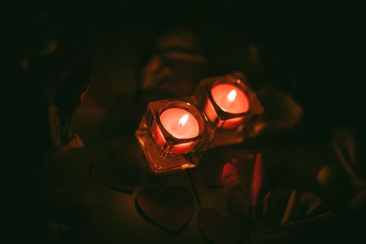 two burning candles on a dark background. photo with copy space