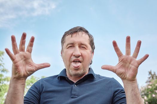 funny man showing tongue at the camera and having a funny look