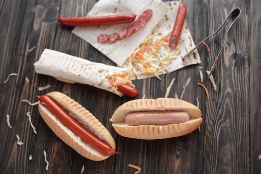 preparation of hot dogs with sausage.photo on a wooden background.