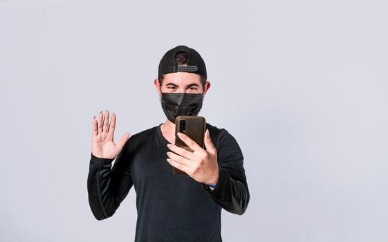 Man making video call isolated, guy making video call with face mask, face mask video call concept