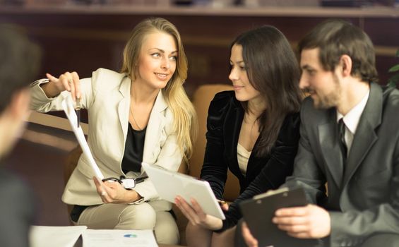 Image of business people listening and talking to their colleague at meeting