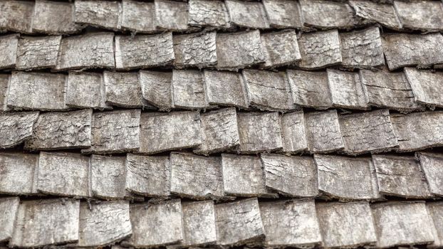 Traditional wooden roof tile of old house. Flat lay photo.