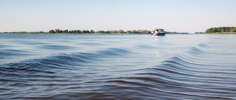 Amazing water waves and a small boat in the lagoon