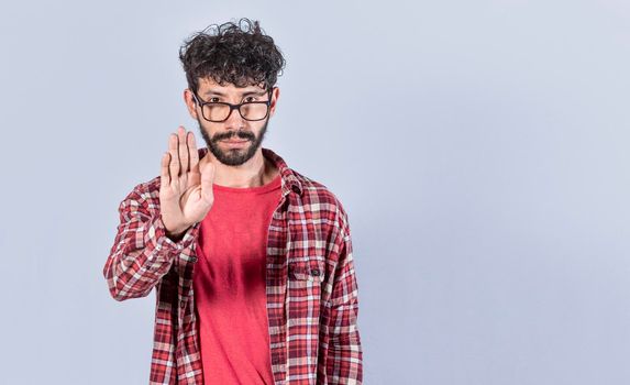 Serious young man stop sign with palm, caucasian man stop sign with hand, stop concept with hand