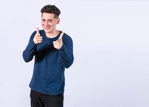 young man with thumbs up on white background, positive boy with thumbs up doing ok, Smiling man showing ok gesture looking at camera