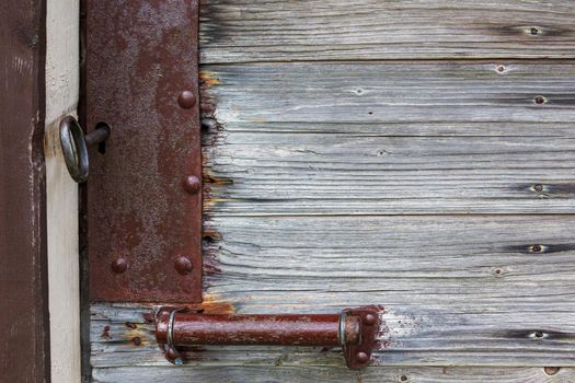 Old medieval rusted iron lock on the front door of a building in Lithuania