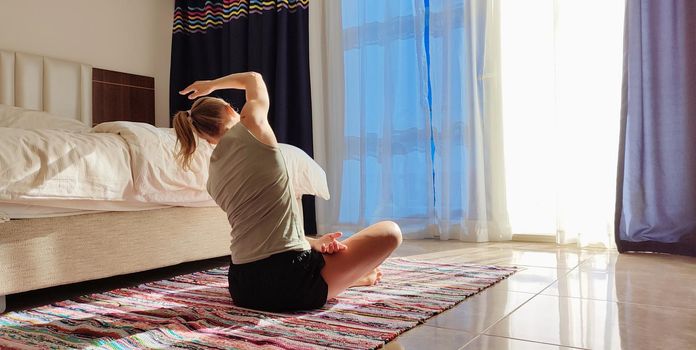 Sport and beauty. Beautiful woman in sportswear workout in hotel room. yoga mat