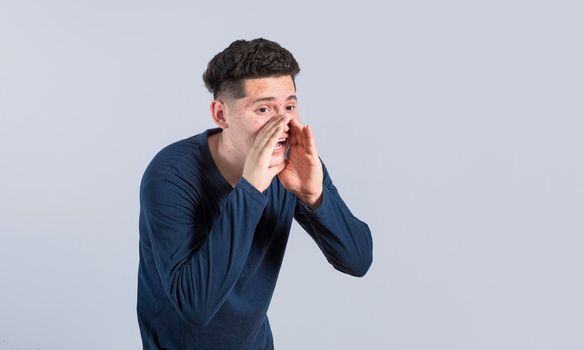 A person announcing and yelling, Handsome man shouting an announcement, isolated.  concept of a guy yelling an announcement