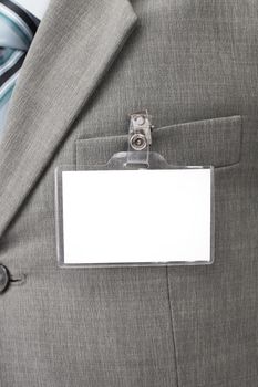 White blank name tag is attached to chest of a businessman .isolated on white