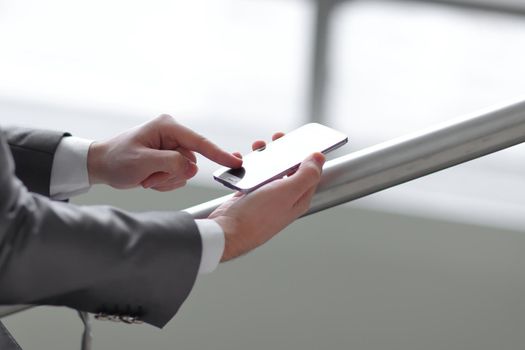 close up .businessman typing SMS on smartphone.