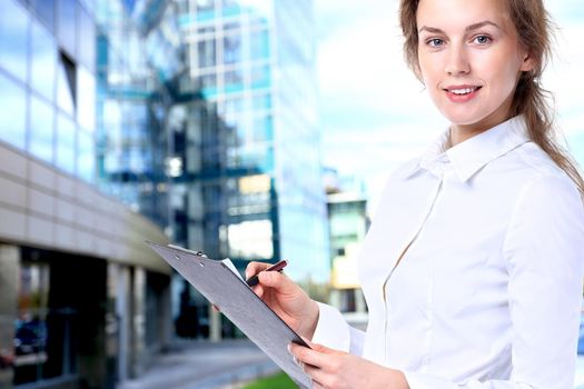 Business lady with positive look and cheerful smile posing for the camera