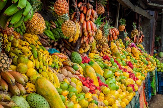 Shelf of many fresh fruits, fresh fruit stall, concept of fruits and healthy food, sale of various fruits