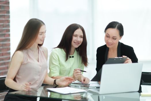 close up.three employees of the company work with documents at the table in the office.