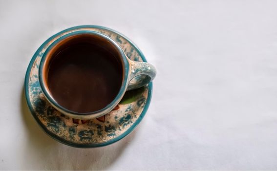 Photo of a cup with coffee on white background, cup of coffee with smoke on white background