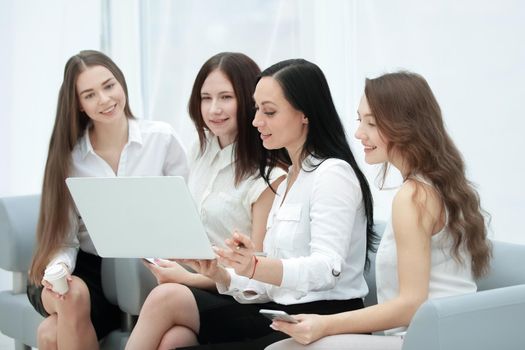 group of employees using laptop to check financial data.