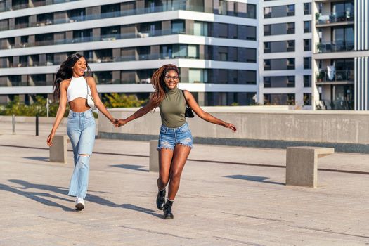 two young black friends have a blast walking around the city, concept of friendship and urban lifestyle, copy space for text