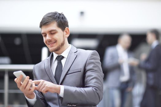 portrait of handsome businessman on blurred office background.photo with copy space