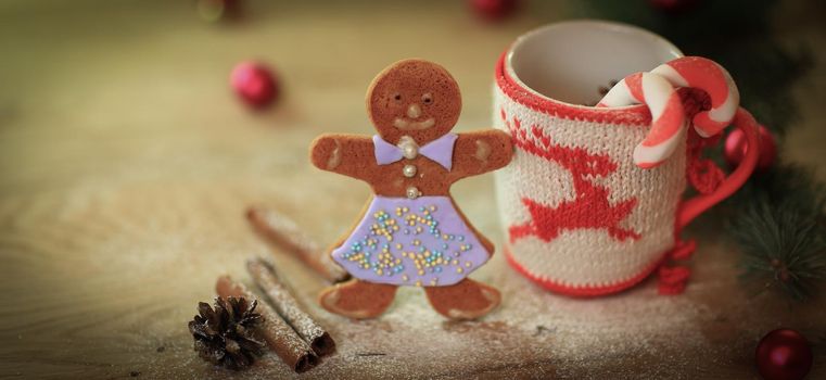 Christmas Cup ornament and candy on a wooden table .photo with copy space