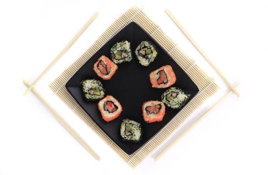 different types of Maki sushi on a black plate.isolated on white background