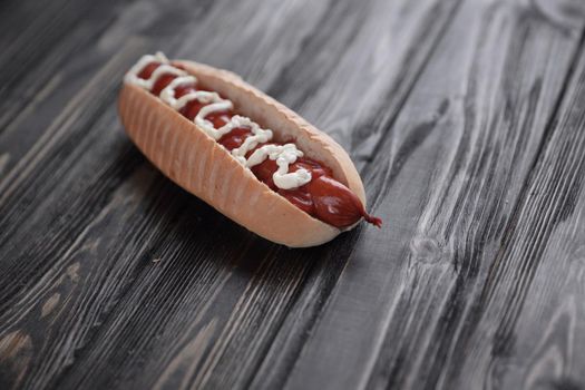hot dog on wooden background.photo with copy space.