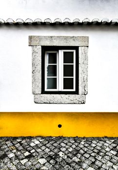 Old colorful and bright typical facade in Lisbon with beautiful vintage wooden window