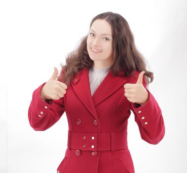 beautiful young woman in red coat showing thumbs up.isolated on white