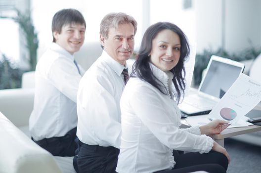 portrait of modern business woman on the background of her workplace in office