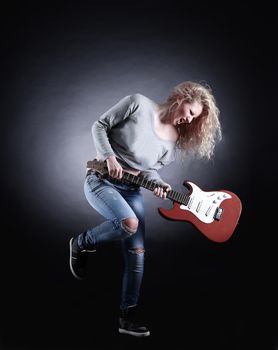 Young and beautiful rock girl playing the electric guitar.the photo has a empty space for your text