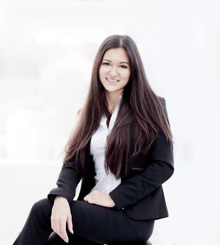 young employee sitting near a window in the office .photo with place for text