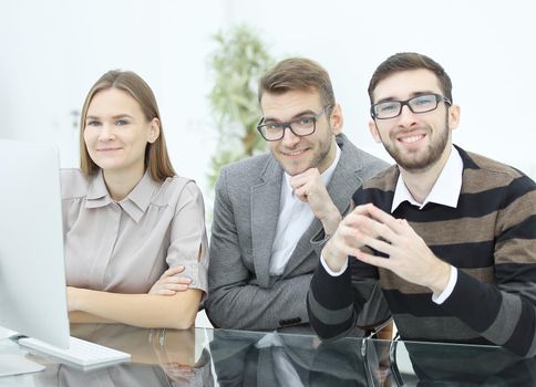 smiling business team sitting at the Desk .photo with copy space.