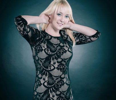 portrait of beautiful young woman in evening black dress. isolated on black.photo with copy space.