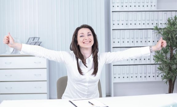 very happy young business woman sitting at her Desk.photo with copy space