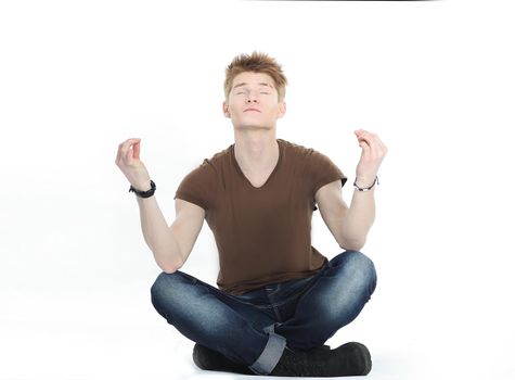 momodern guy meditates sitting on the floor.isolated on white background