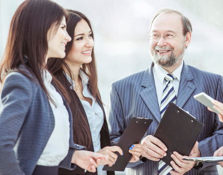 boss and business team with tablet and work documents on the background of the office.