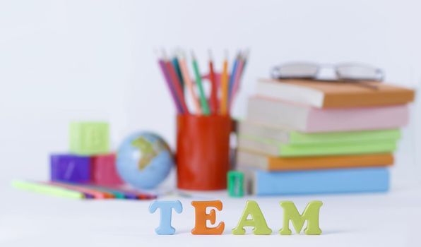 word team on blurred background of school supplies .photo with copy space.