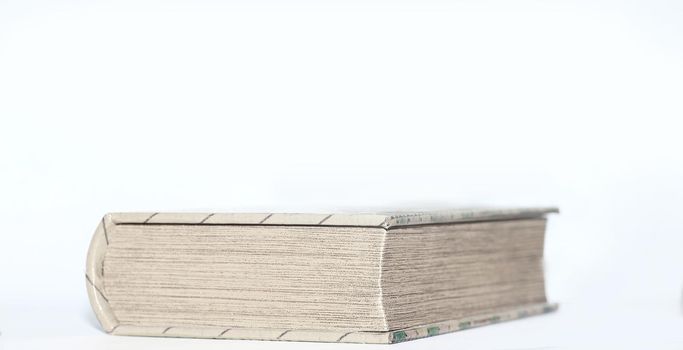 close up.thick closed book on white background.