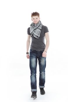 young man in a t-shirt and scarf ,confidently goes forward.isolated on a white background.