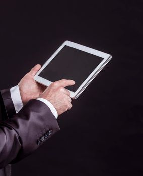 businessman with digital tablet on black background. the photo has a empty space for your text