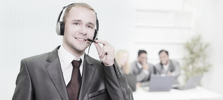 foreground a responsible employee call center with headset on the background of the office .photo with copy space