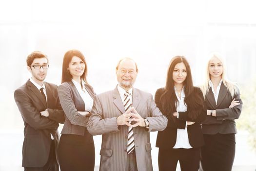 Portrait of an handsome businessman in front of his working team.photo with copy space