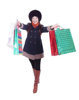 young woman in winter clothes with shopping bags .isolated on white background