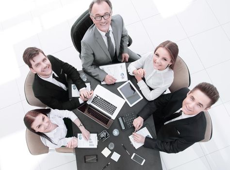 top view.business team at a Desk looking at the camera.the concept of teamwork