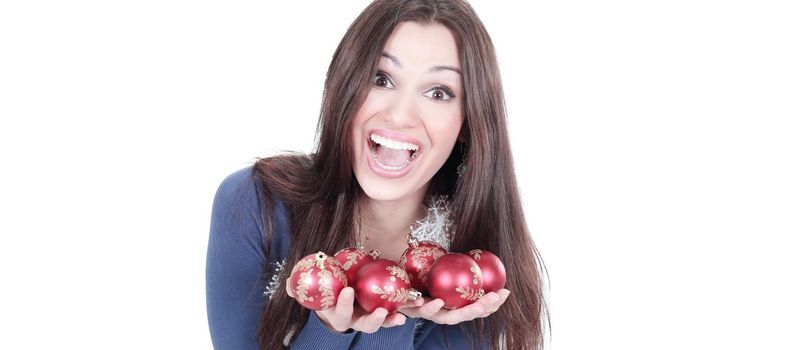 very happy young woman showing Christmas balls.isolated on a white background