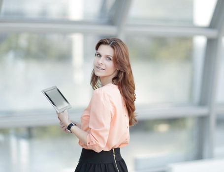 side view.confident business woman with digital tablet .photo with place for text