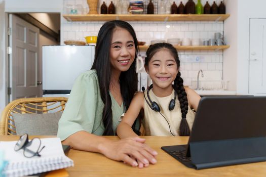 Homeschool Asian mother and little young girl student learning online class. E-learning Online Education concept