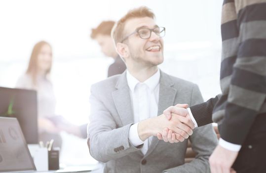 Manager and the client shake hands when meeting in the office.concept of partnership