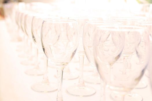 catering table set service with silverware and glass stemware at restaurant before party