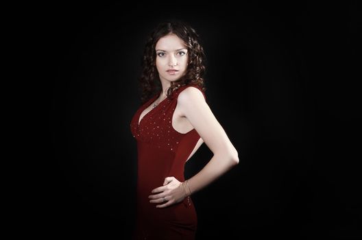 beautiful woman in red dress with evening make-up .isolated on black background