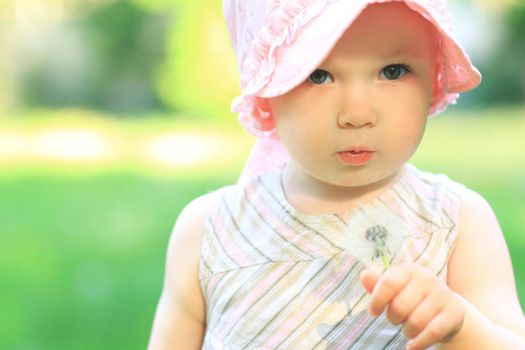 Little cute girl walking in a summer Park