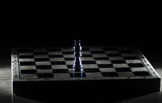black king on a chessboard . photo with copy space.